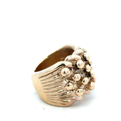 9ct yellow gold keeper ring in size W, unbranded, with a smooth band and secure clasp, shown in a close-up image.