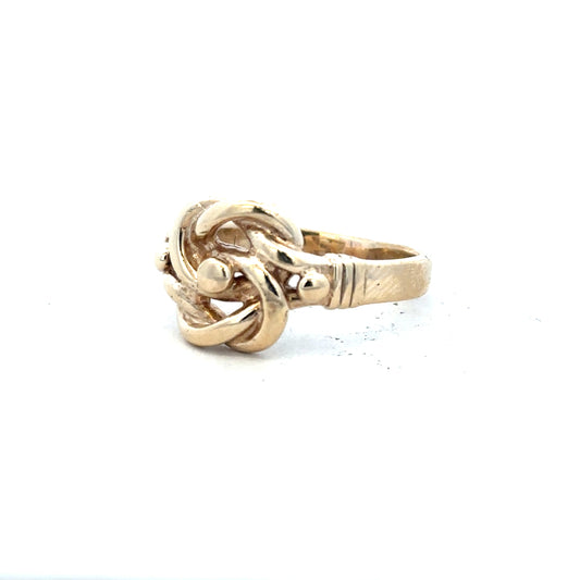 9ct yellow gold knot ring in size Z1, featuring a polished gold band with a decorative knot design.