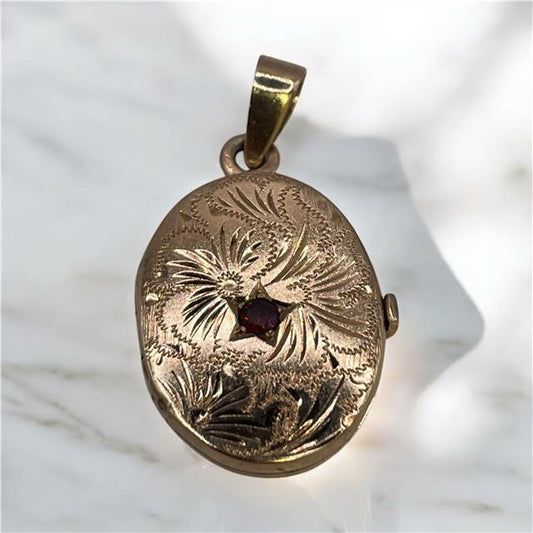 9ct yellow gold locket weighing 3.5g, unbranded, with intricate design visible in this detailed image.