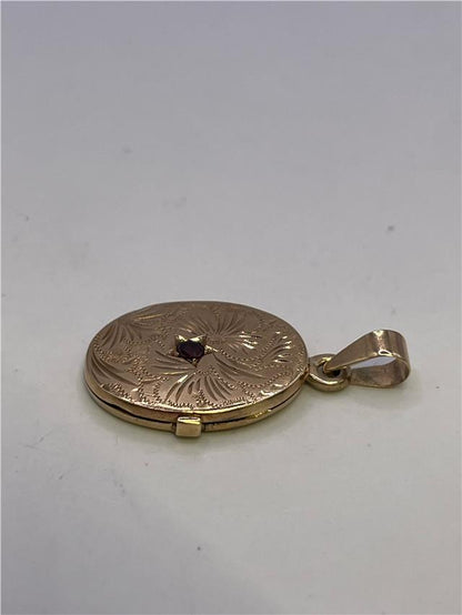 9ct yellow gold locket weighing 3.5g, unbranded, with a classic design, shown in a close-up image highlighting its polished surface.