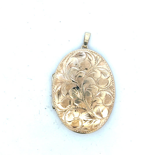 9ct yellow gold locket pendant showing intricate design and polished surface, weighing 13.8 grams, unbranded jewelry accessory.