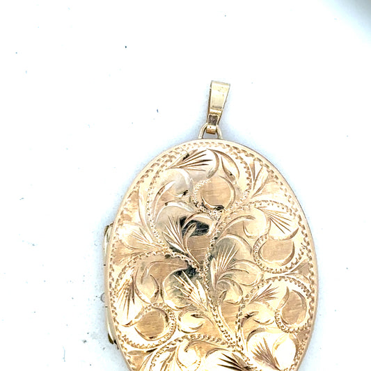9ct yellow gold locket pendant weighing 13.8g, unbranded, featuring a classic design with a smooth polished surface.