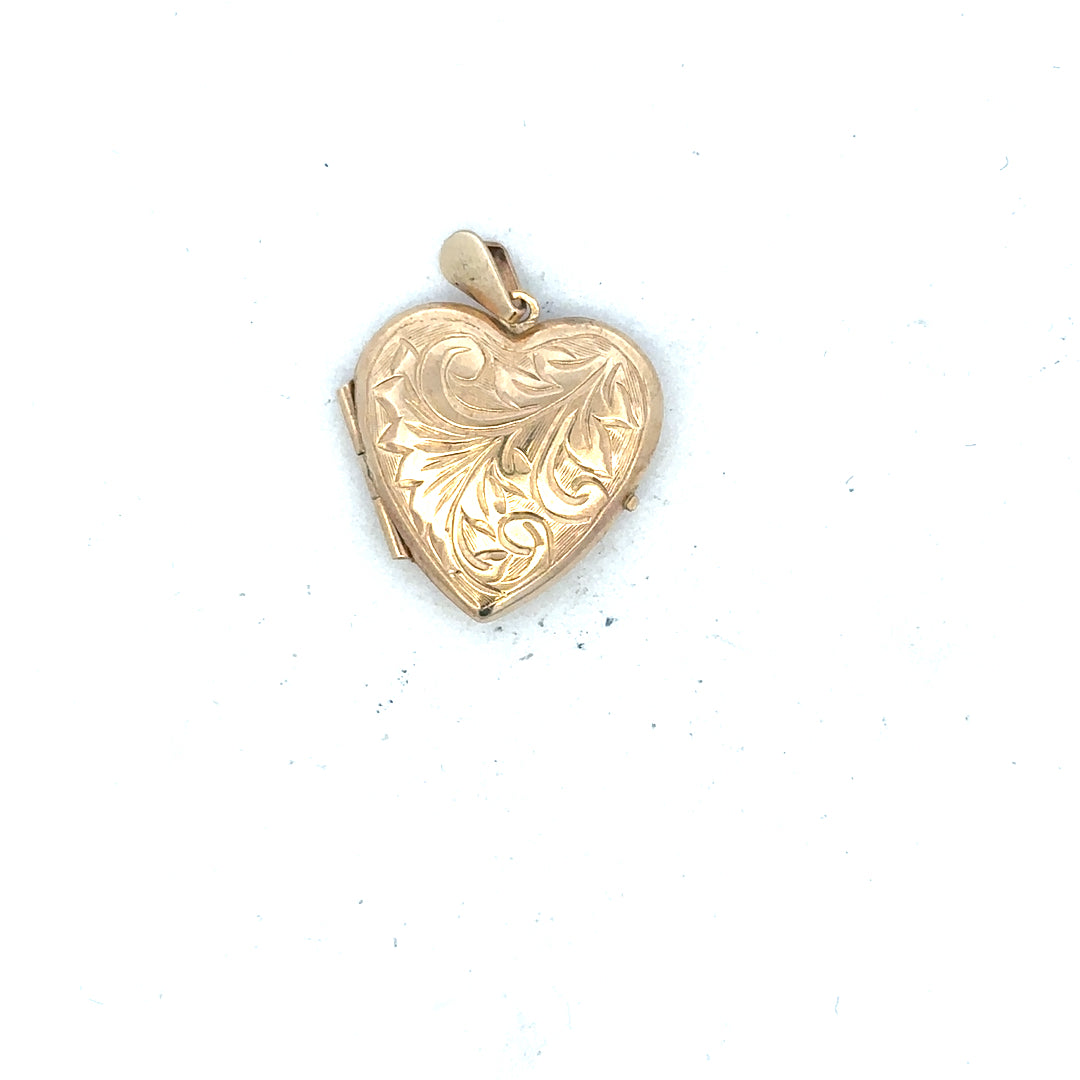 9ct yellow gold locket pendant weighing 2.5g, unbranded jewelry with intricate design, shown in close-up detail.