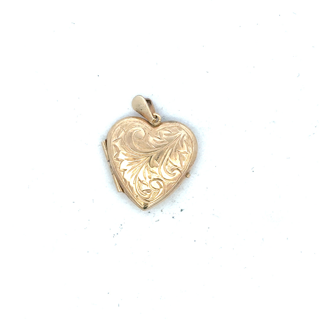 9ct yellow gold locket pendant, 2.5g, unbranded, with intricate engraved design, hanging on a delicate chain.