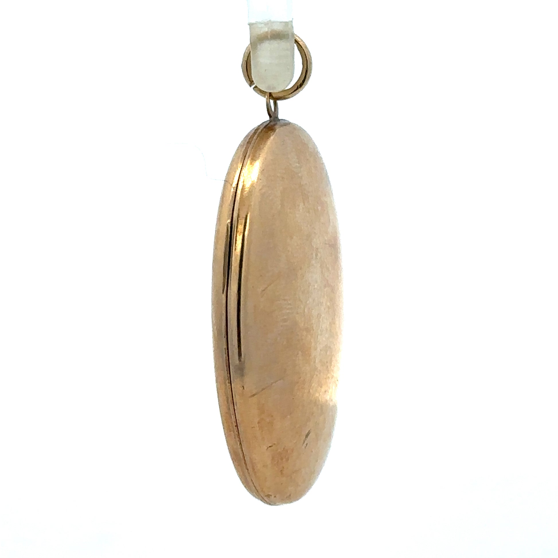9ct yellow gold locket pendant weighing 5.8g, unbranded, with intricate design, shown in a close-up image.
