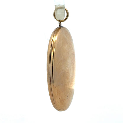9ct yellow gold locket pendant weighing 5.8g, unbranded, with intricate design, shown in a close-up image.