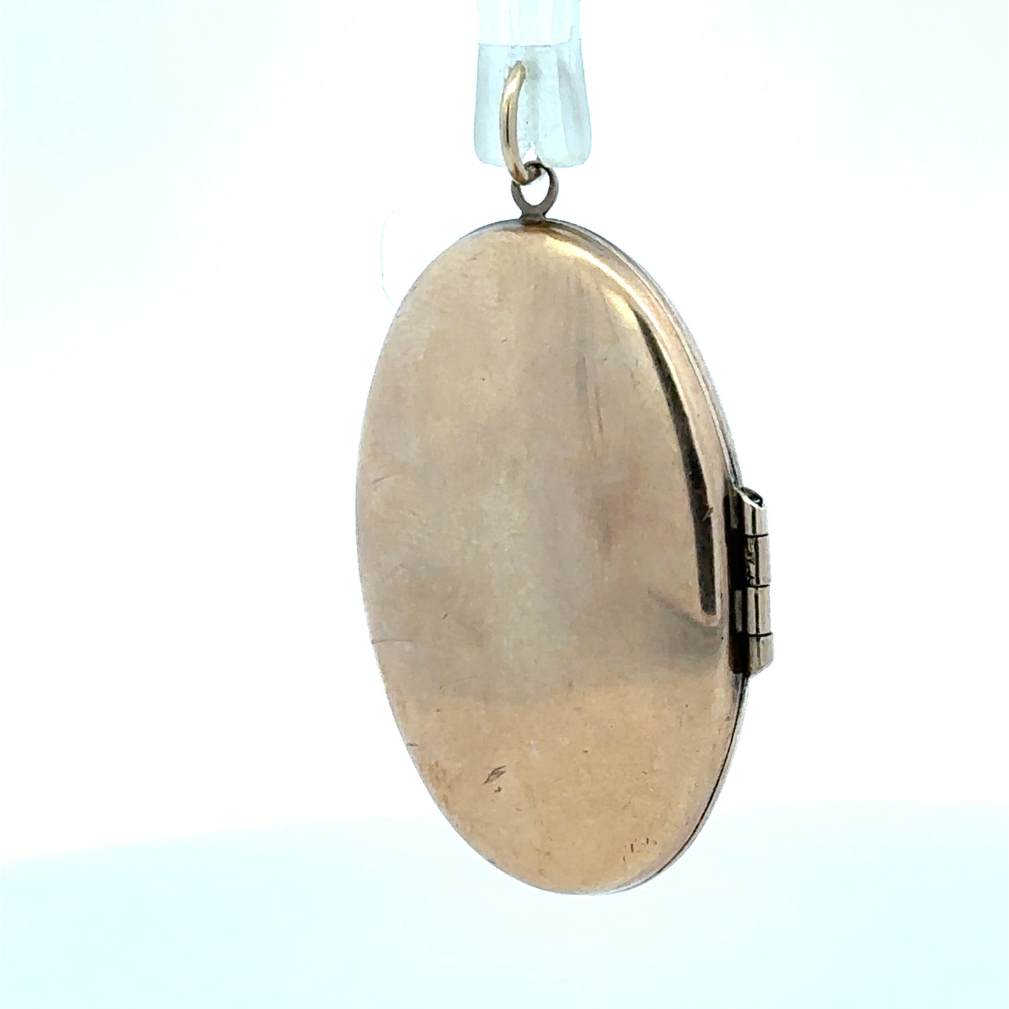 9ct yellow gold locket pendant weighing 5.8g, unbranded, featuring a classic design with a smooth polished surface.