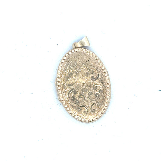 9ct yellow gold locket pendant weighing 6.3g, unbranded, with a polished finish and detailed engraved design.