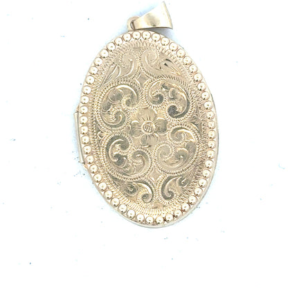 9ct yellow gold locket pendant weighing 6.3g, unbranded, with intricate design visible in the image.