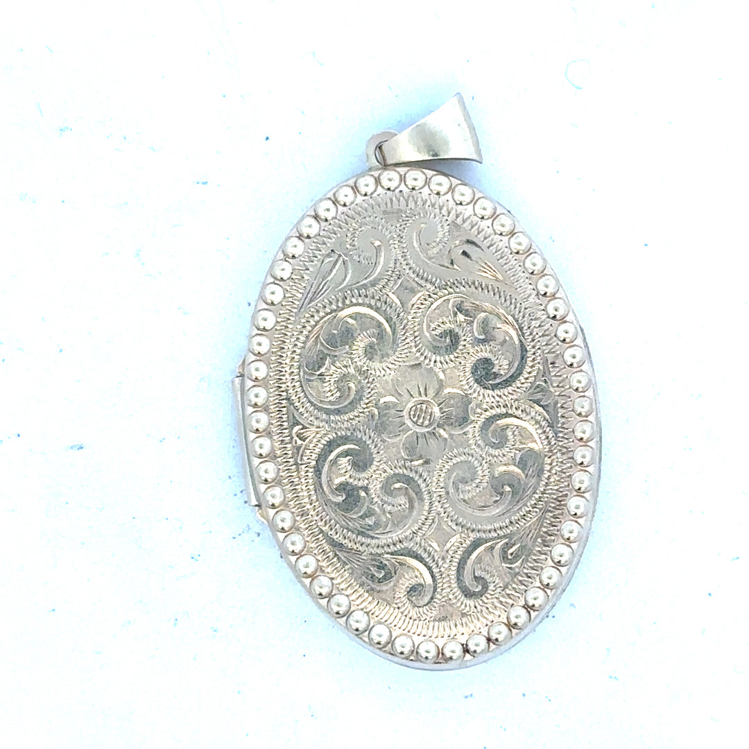 9ct yellow gold locket pendant weighing 6.3g, unbranded, with detailed design visible in the image.