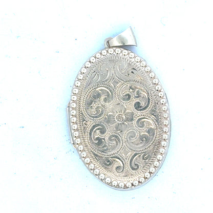 9ct yellow gold locket pendant weighing 6.3g, unbranded, with detailed design visible in the image.