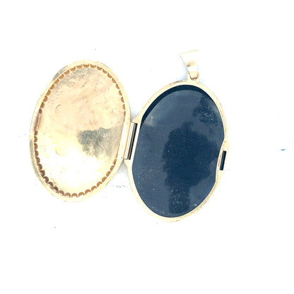 9ct yellow gold locket pendant weighing 6.3g, unbranded, featuring a classic design with intricate detailing on the surface.