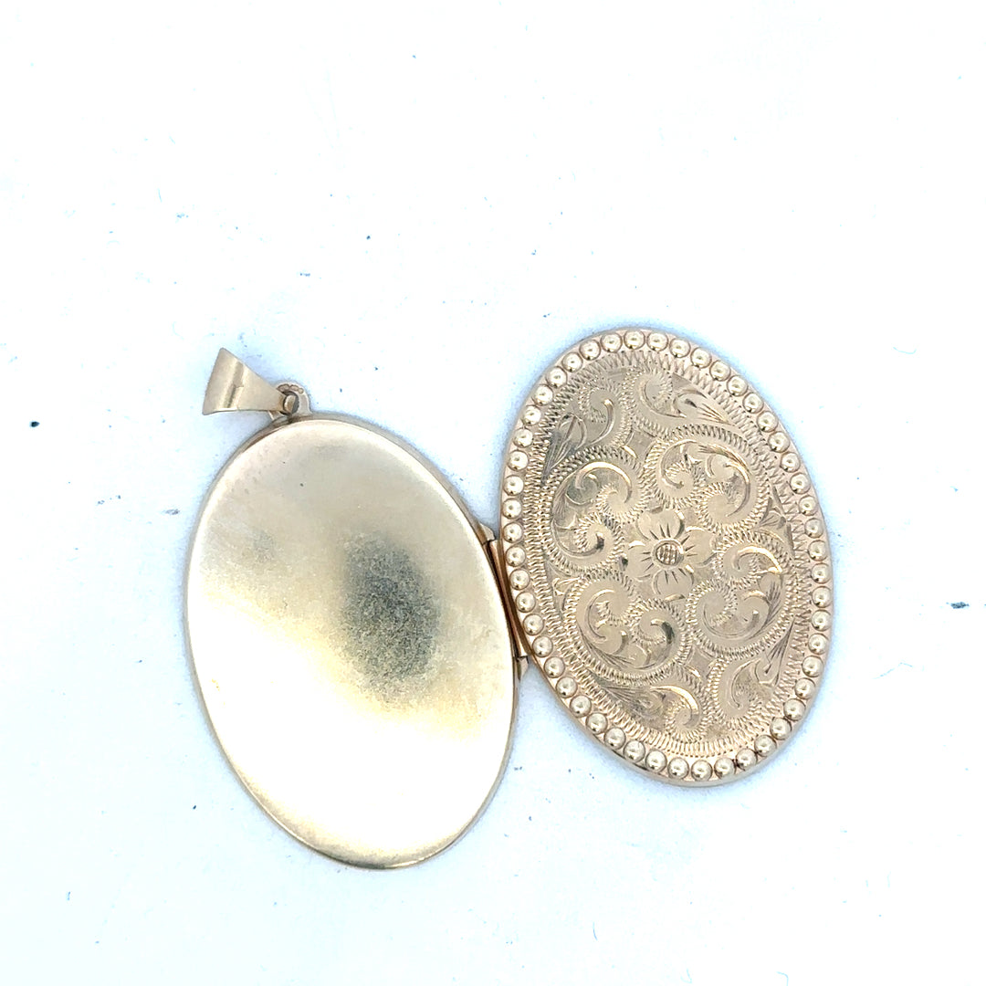 9ct yellow gold locket pendant weighing 6.3g, unbranded, featuring a classic design with a smooth polished surface.