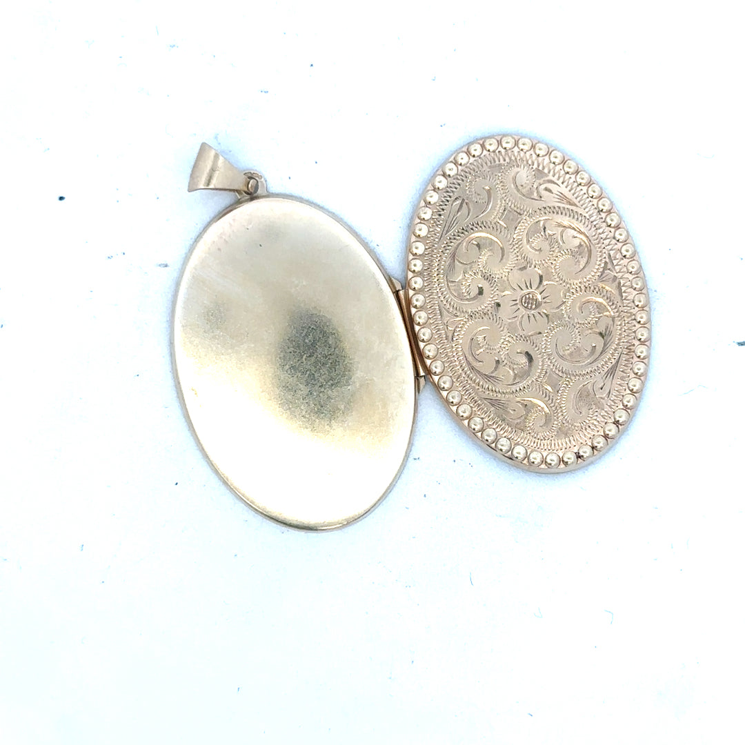 9ct yellow gold locket pendant weighing 6.3g, unbranded, with intricate design visible in the image.