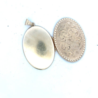9ct yellow gold locket pendant weighing 6.3g, unbranded, with intricate design visible in the image.