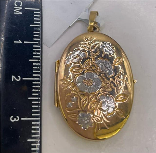 9ct yellow gold locket with intricate engraved design, unbranded pendant, oval shape, suitable for holding small photos or keepsakes.
