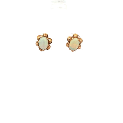 9ct yellow gold opal earrings with vibrant, iridescent stones set in a simple gold setting, weighing 2.1 grams.