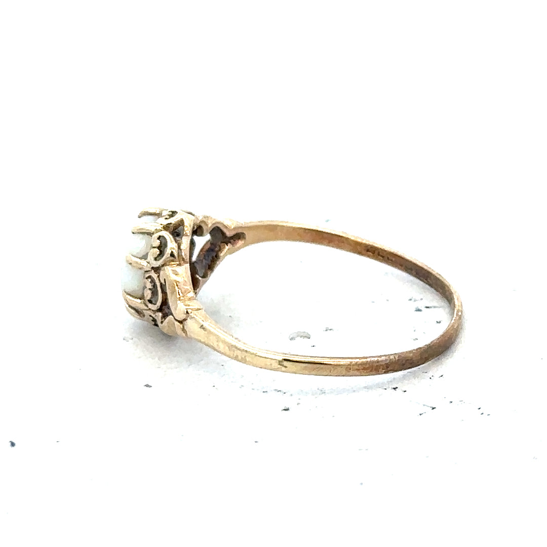 9ct yellow gold opal ring in size P with a vibrant oval opal gemstone, featuring a polished gold band.