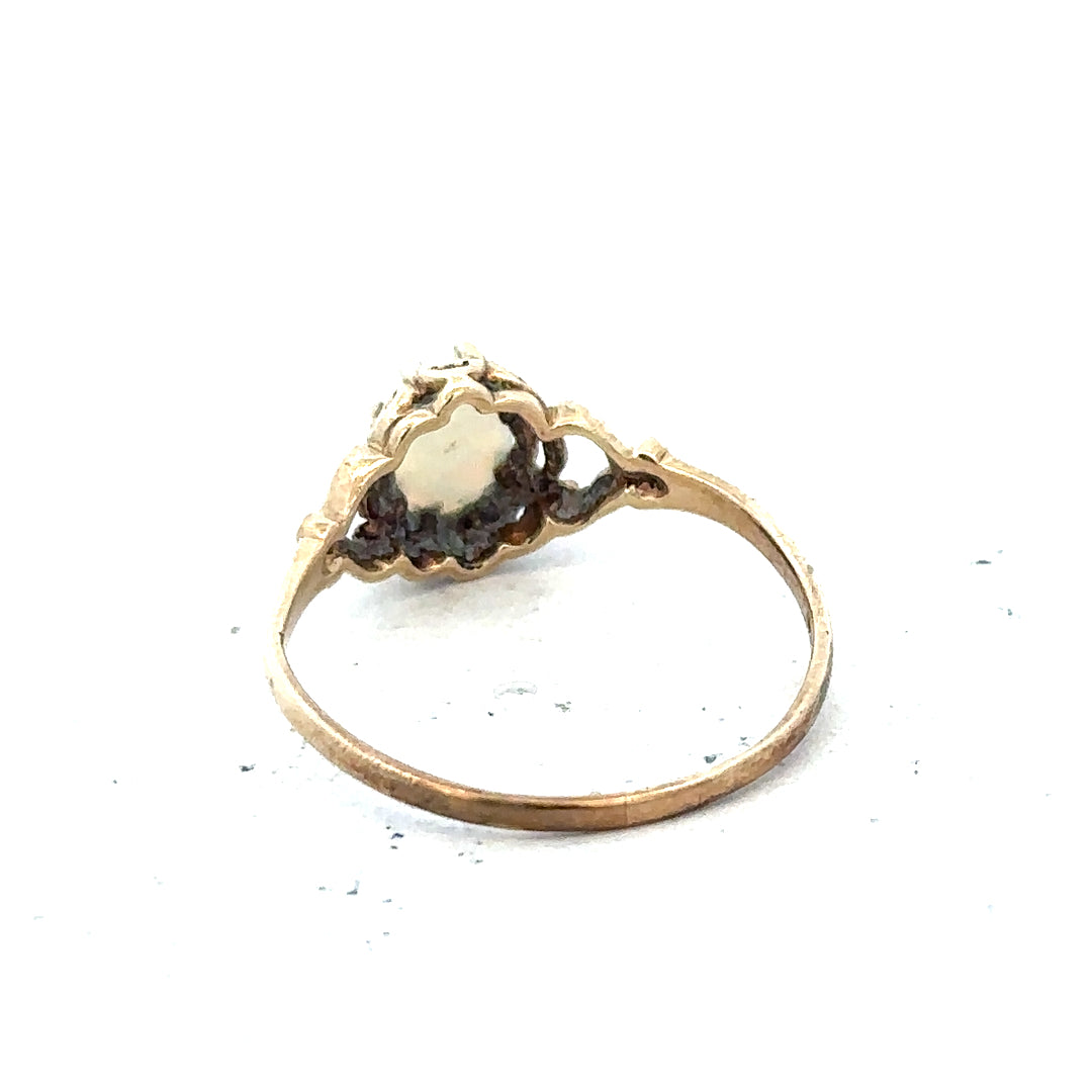 9ct yellow gold opal ring in size P with a vibrant, oval-shaped opal gemstone, showcasing elegant jewelry craftsmanship.