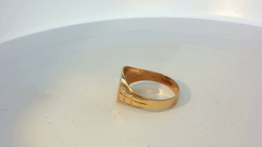 9ct yellow gold ring with a smooth band, unbranded jewelry, shiny gold finish, displayed against a neutral background.