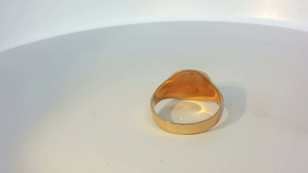 9ct yellow gold ring with a smooth polished finish, featuring a simple band design.