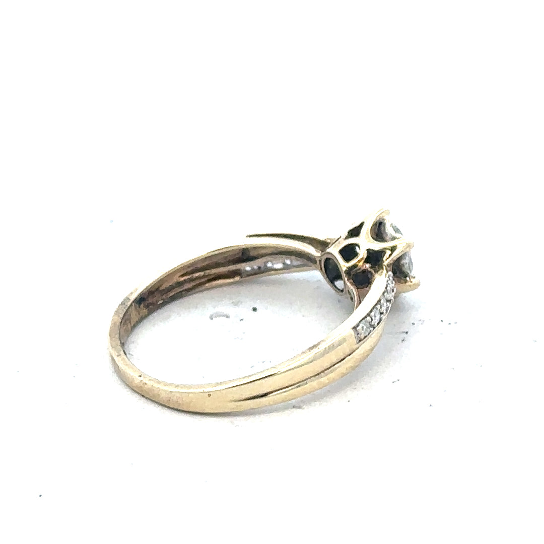 9ct yellow gold ring in size L with a simple band design, unbranded jewelry displayed on a plain background.