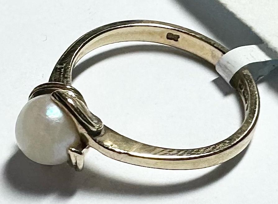 9ct yellow gold ring in size L 1/2 with a smooth band, unbranded jewelry display, shiny and polished finish.