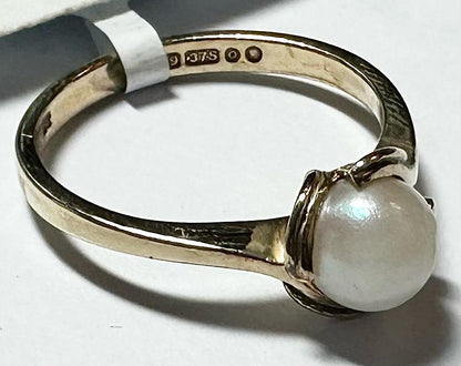 9ct yellow gold ring in size L1/2 with a smooth band, unbranded jewelry, shown from a side view.