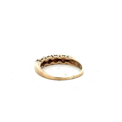 9ct yellow gold ring in size N with a smooth polished band, unbranded, shown from a side angle.