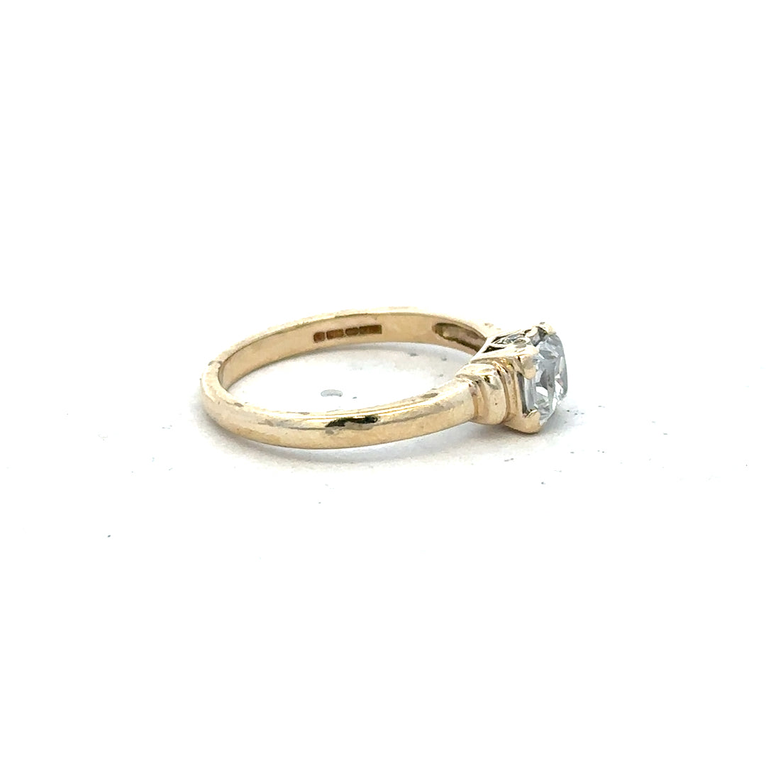 9ct yellow gold ring in size O with a smooth band, unbranded jewelry piece, shown from a top view.