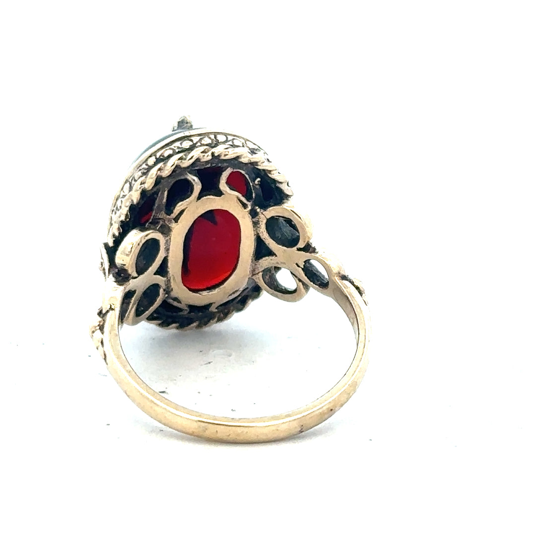 9ct yellow gold ring in size P with a smooth band, unbranded jewelry piece on a plain background.