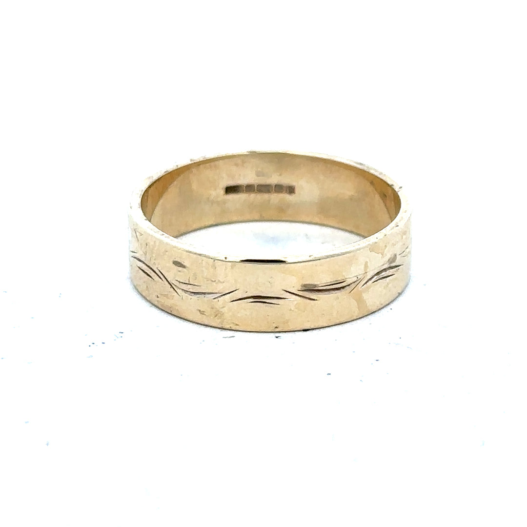 9ct yellow gold ring size S, unbranded jewelry with a smooth band, shown on a plain background in a close-up view.
