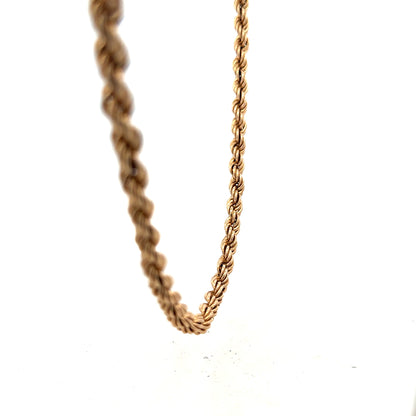 9ct yellow gold rope chain weighing 15.1g, showcasing its twisted design and polished finish on a plain background.