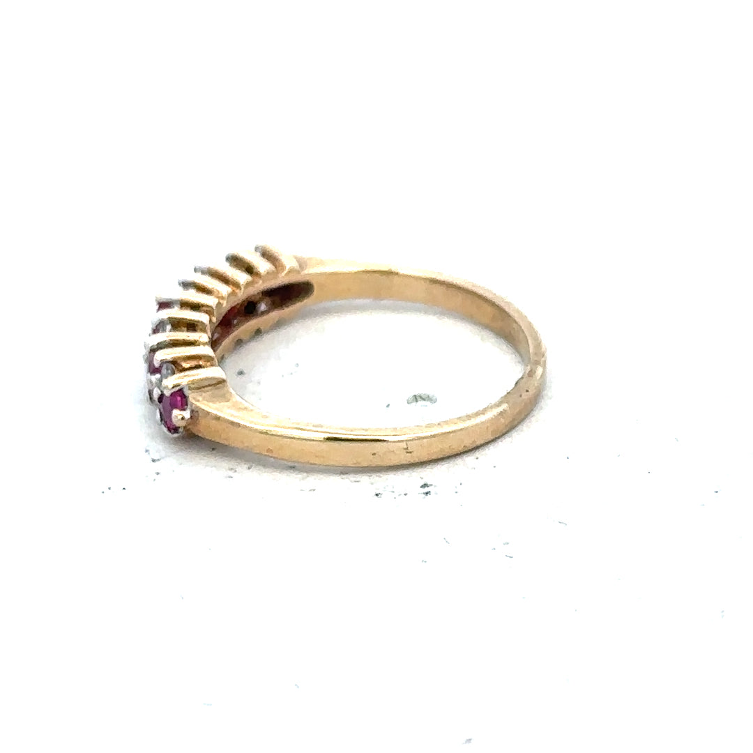 9ct yellow gold ruby and diamond ring in size J½, featuring a vibrant ruby centerpiece and sparkling diamonds.