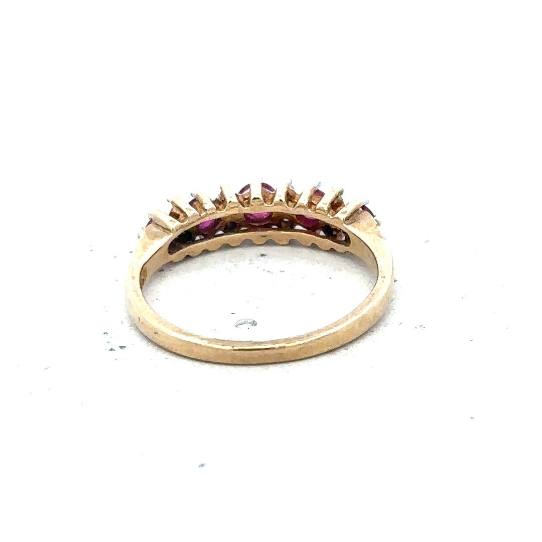 9ct yellow gold ruby and diamond ring, size J½, featuring a vibrant ruby centerpiece and sparkling diamonds.