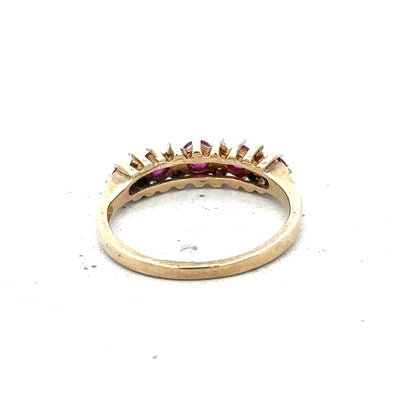 9ct yellow gold ruby and diamond ring, size J½, featuring a vibrant ruby centerpiece and sparkling diamonds.