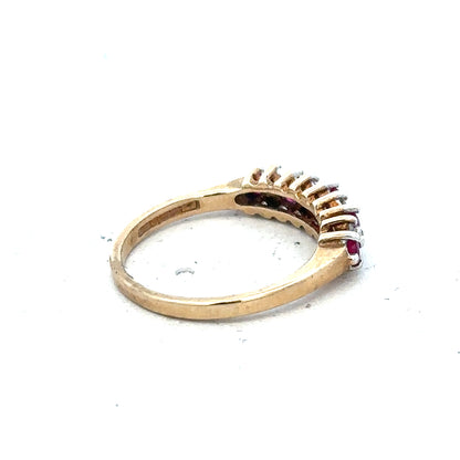 9ct yellow gold ruby and diamond ring in size J½, featuring a central ruby surrounded by sparkling diamonds.