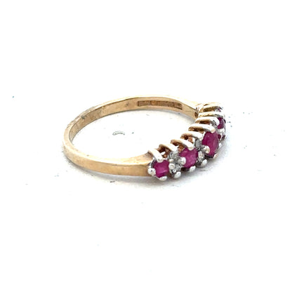 9ct yellow gold ruby and diamond ring in size J½, featuring a central ruby surrounded by sparkling diamonds.