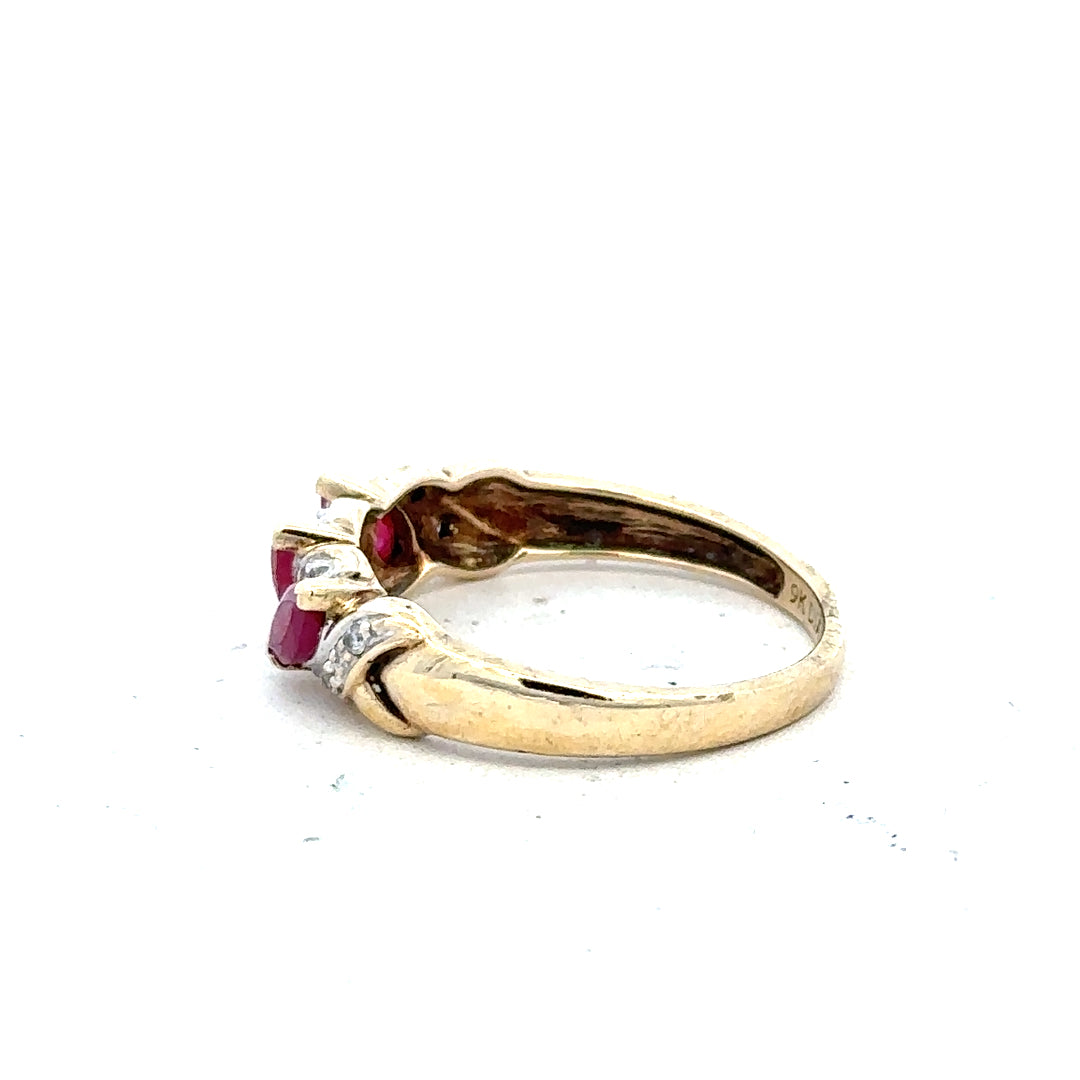9ct yellow gold ruby and diamond ring in size L, showcasing a vibrant ruby centerpiece with sparkling diamonds.