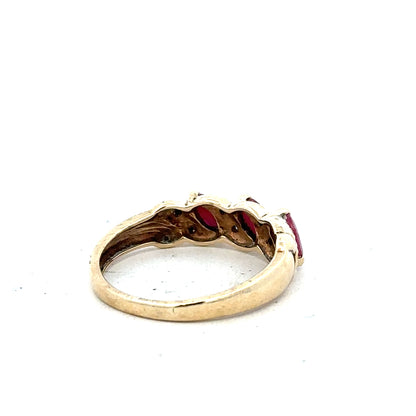 9ct yellow gold ruby and diamond ring in size L, featuring a central ruby with accent diamonds, unbranded jewelry.