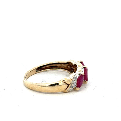 9ct yellow gold ruby and diamond ring in size L, featuring a central ruby surrounded by small diamonds, elegant jewelry piece.