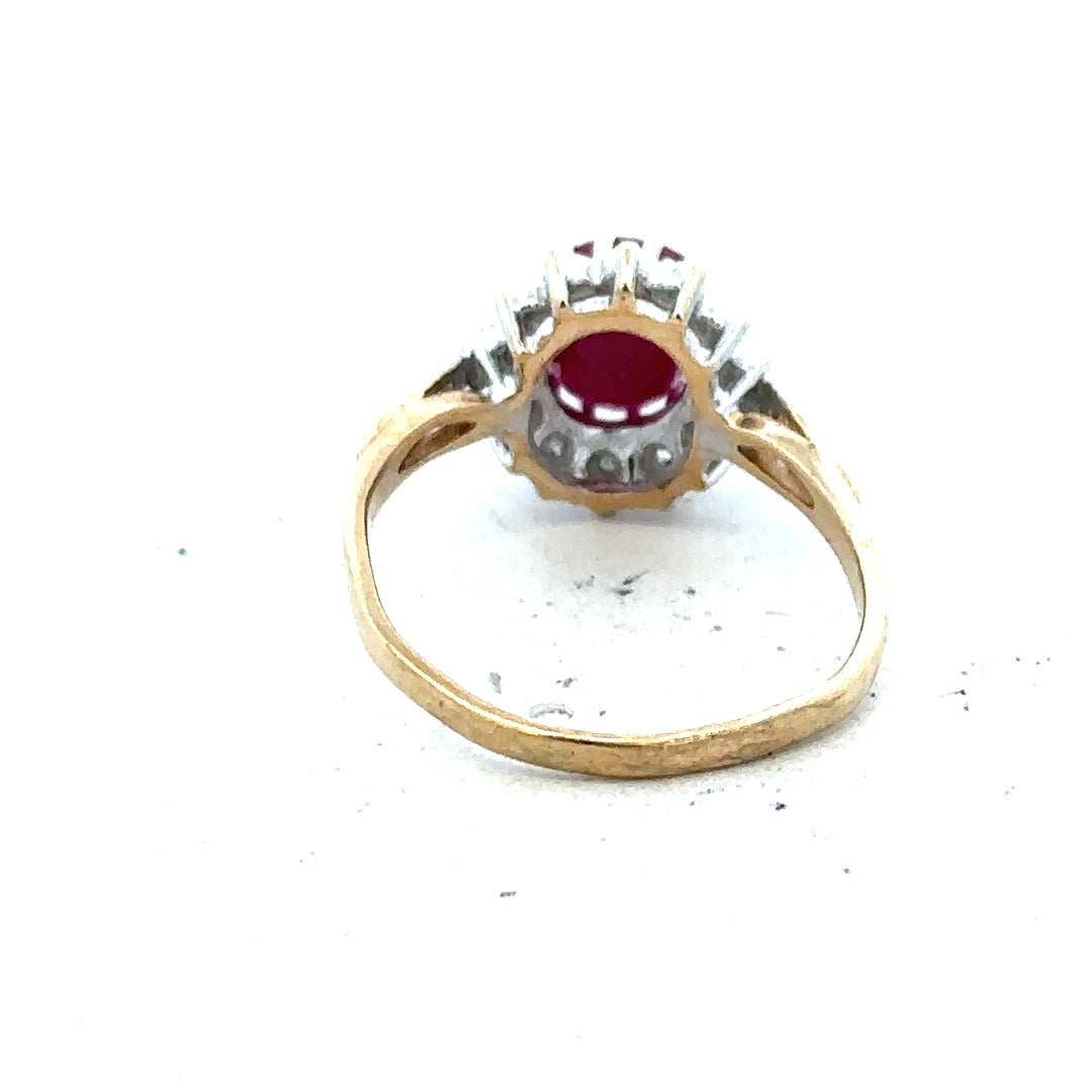 9ct yellow gold ruby and diamond ring size L, featuring a vibrant ruby centerpiece surrounded by sparkling diamonds.