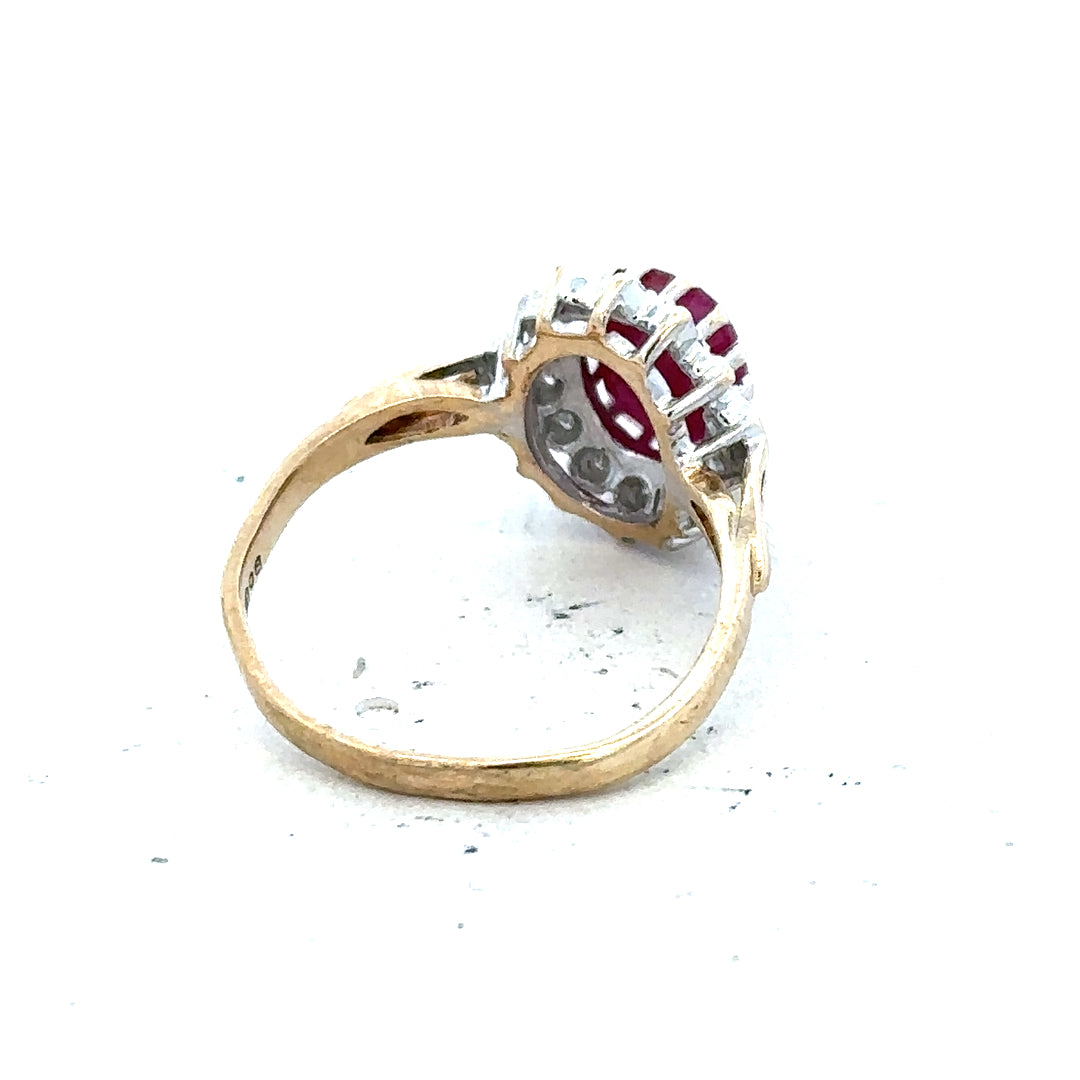 9ct yellow gold ruby and diamond ring in size L, featuring a central ruby surrounded by diamonds, elegant jewelry design.
