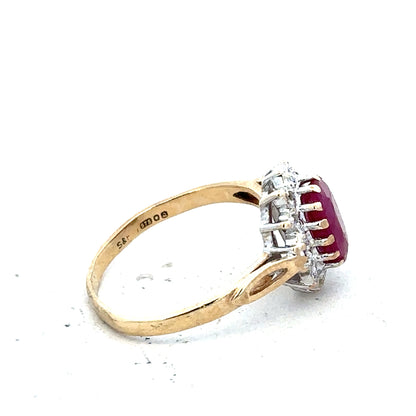 9ct yellow gold ruby and diamond ring in size L, featuring a central ruby gemstone and sparkling diamonds.