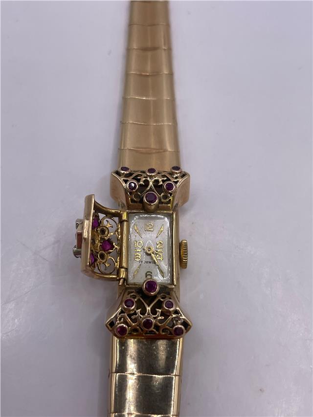 9ct yellow gold ruby and diamond watch with a sleek design, weighing 34.3 grams, unbranded, stylish timepiece.