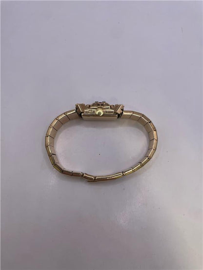 9ct yellow gold ruby and diamond watch with a sleek design, featuring a round face and elegant bracelet.