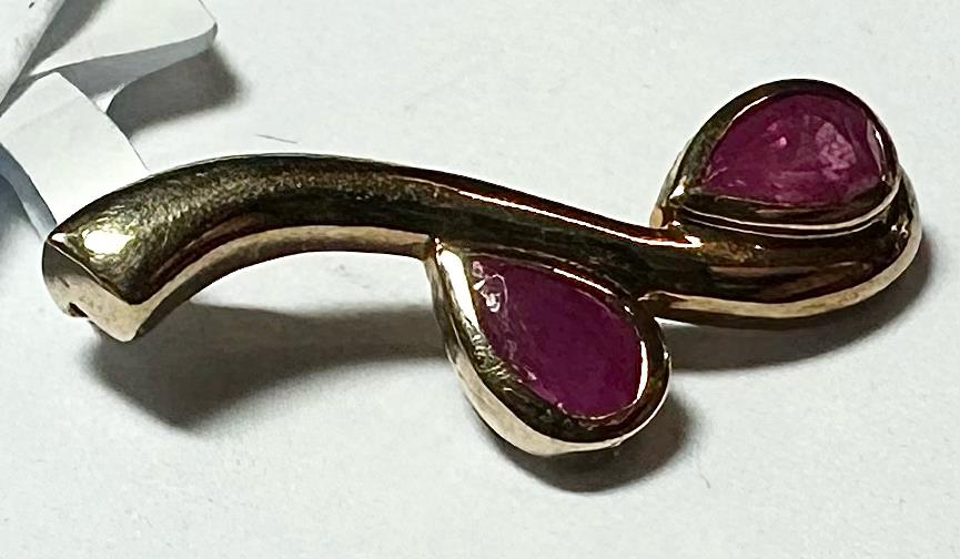 9ct yellow gold ruby pendant, delicate jewelry piece with vibrant red gemstone, handcrafted with a gold chain.