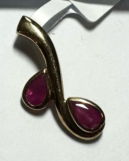 9ct yellow gold ruby pendant weighing 1.2g, featuring a vibrant red ruby gemstone on a simple gold chain.