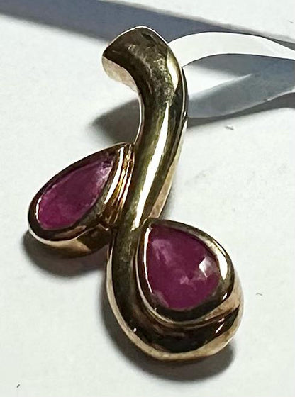 9ct yellow gold ruby pendant weighing 1.2g, featuring a vibrant ruby gemstone set in a simple gold setting.