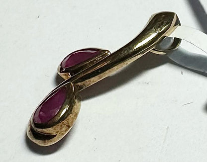 9ct yellow gold ruby pendant weighing 1.2g, featuring a vibrant red ruby gemstone on a simple gold chain.